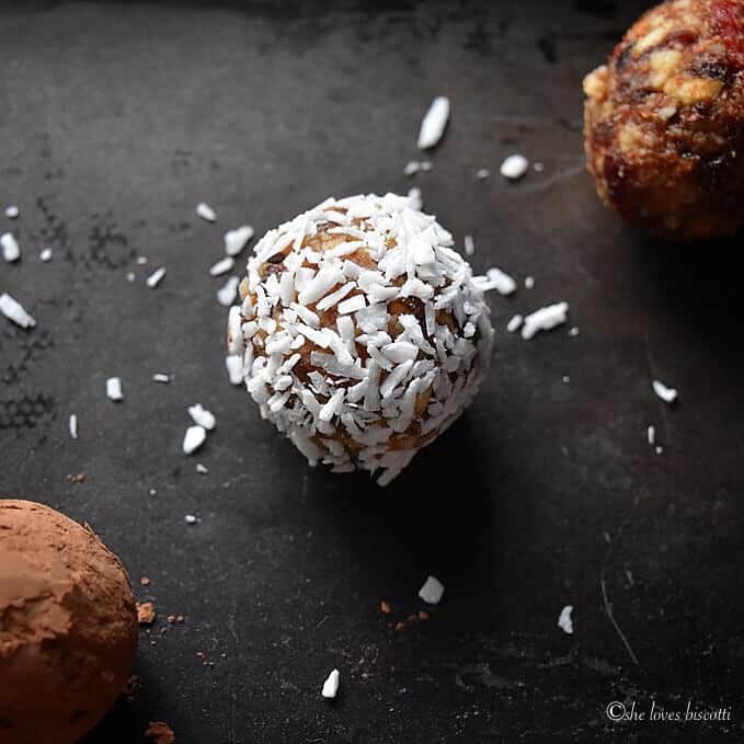 A single Greek Yogurt Goji Berry Almond Date Energy Bite covered in coconut.