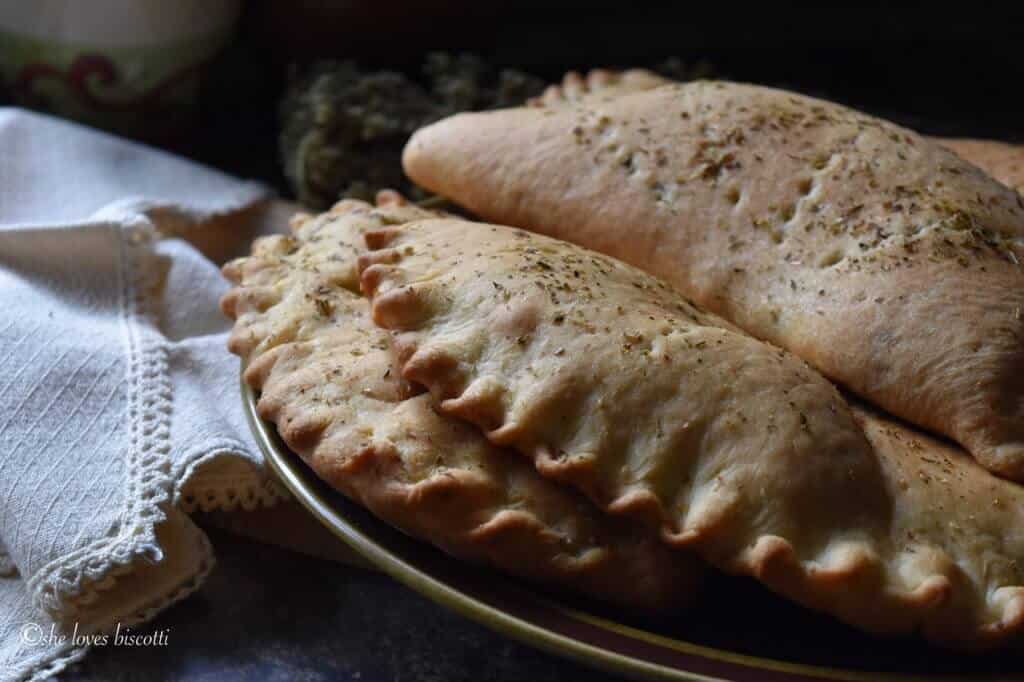 A few calzones on a plate.