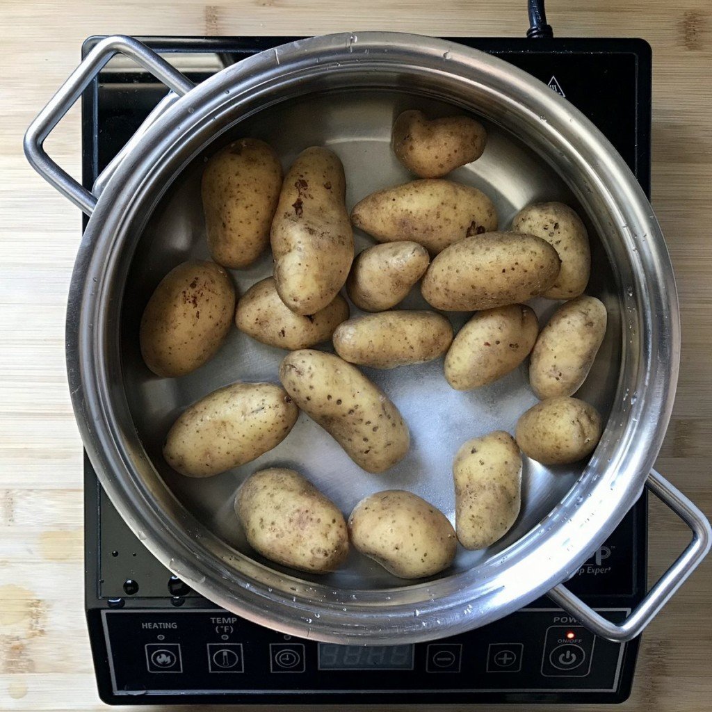 Fingerling potatoes in a pot of water, about to be boiled.