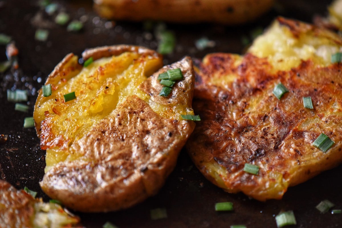 A close up of the crispy texture of smashed potatoes.