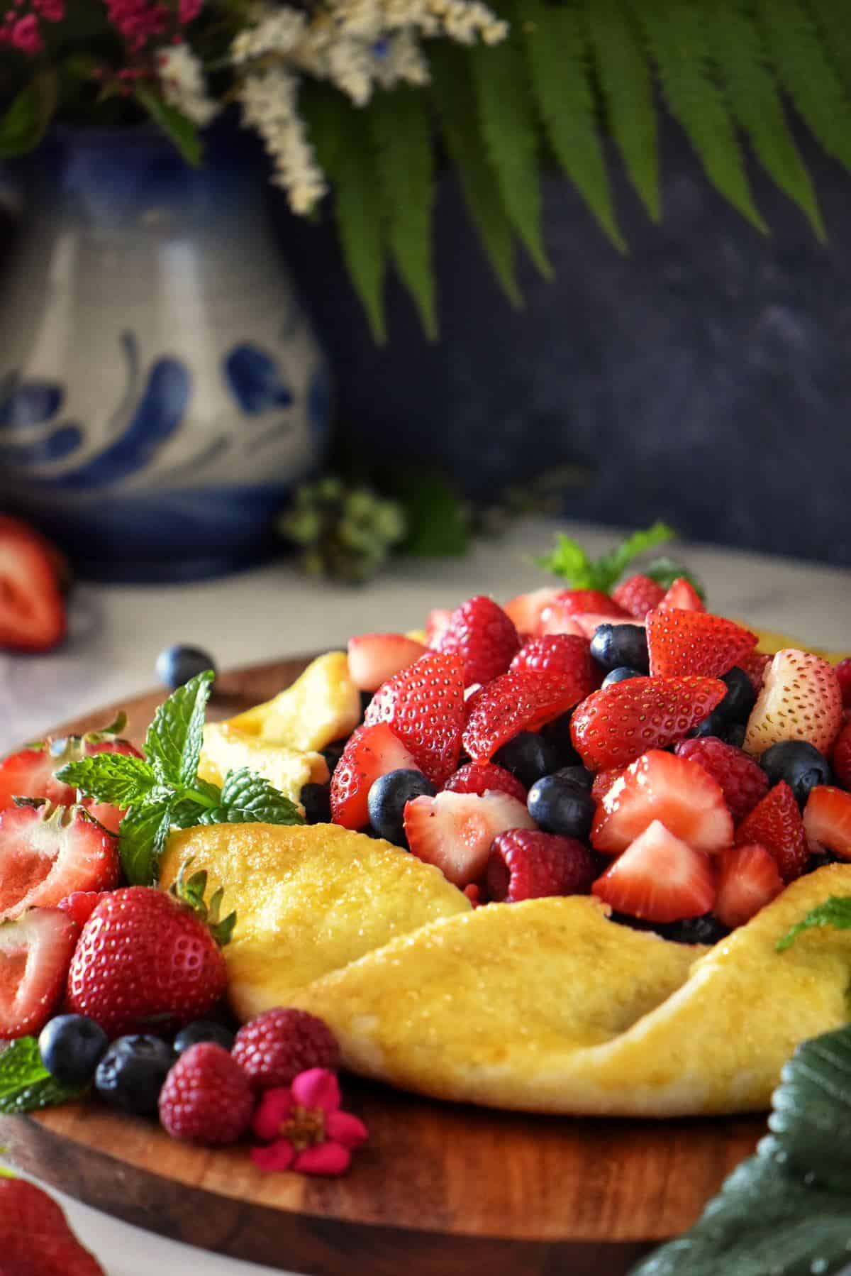 A very colorful berry crostata on a silver serving tray.