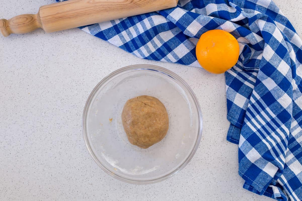 A ball of dough is place in a mixing bowl,