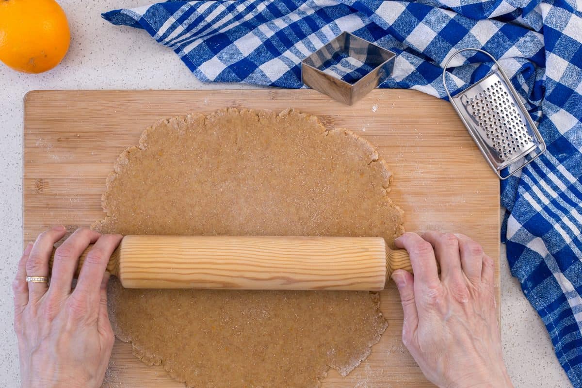 The ball of dough is being rolled out to make whole wheat cookies.