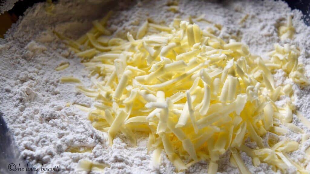Grated butter about to be incorporated with the dry ingredients to make homemade biscuits.