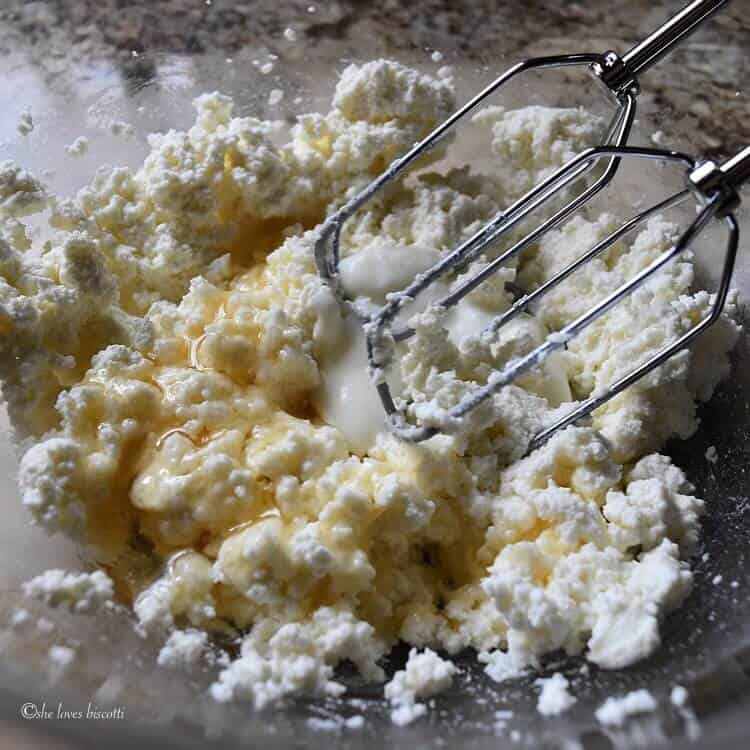 A close up shot of the ricotta, honey and yogurt about to be whipped together.