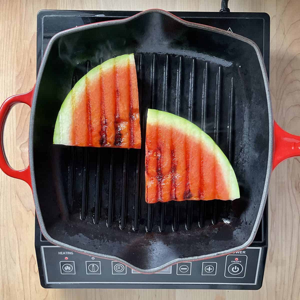 Slices of watermelon on a grill.