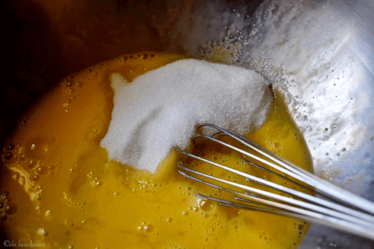 The sugar and the eggs being whisked together to make the cinnamon cookies.