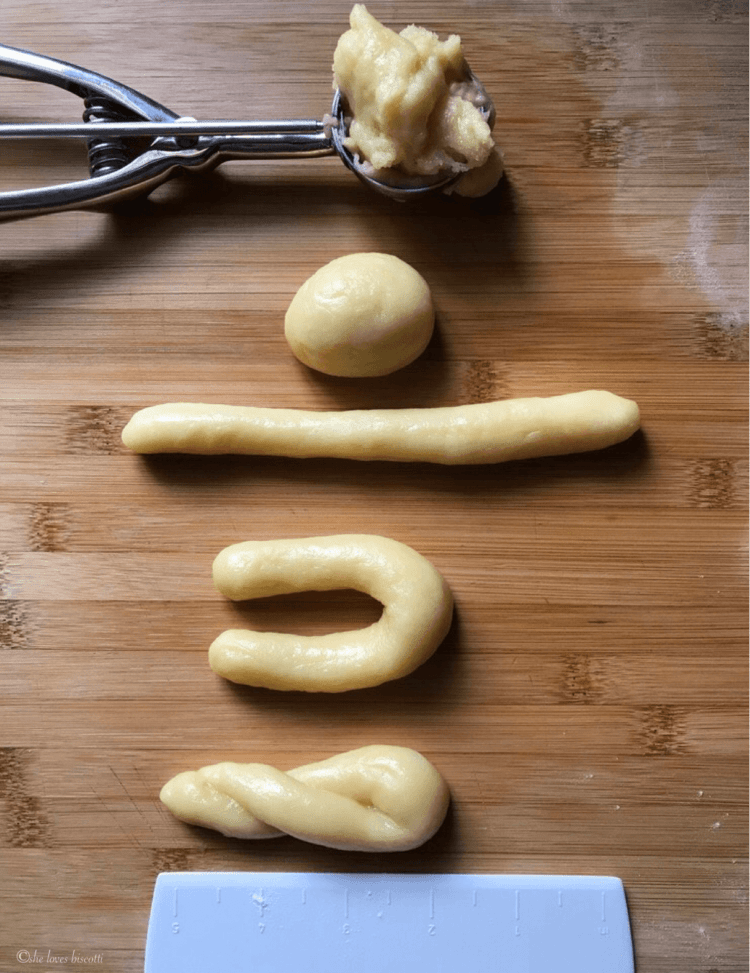 The shaping of a lemon cookie form the scoop of cookie dough, to the rolling ina log, to the formation of a U and finally twisting into shape.