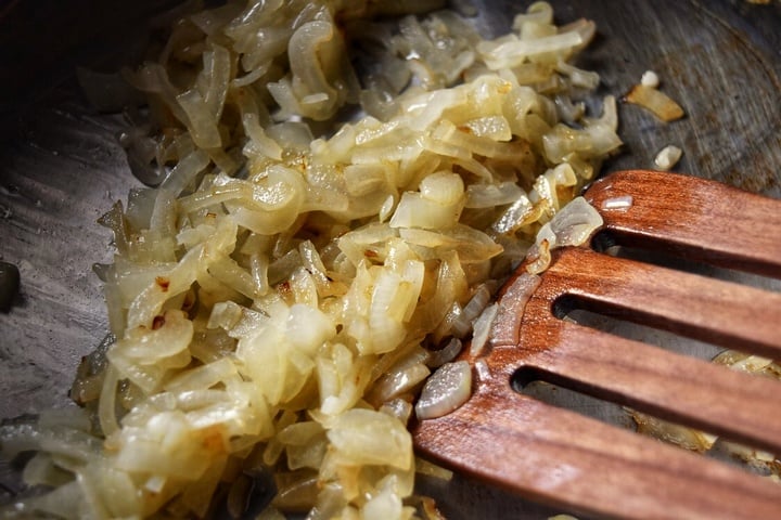 Onions being sauteed in preparation for the green beans recipe.