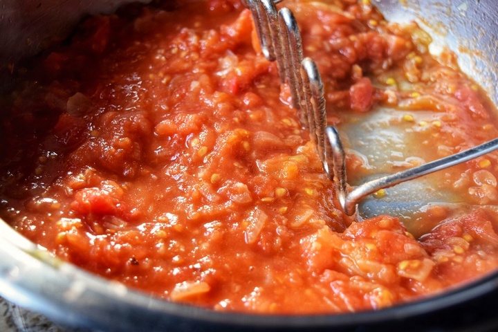 Tomatoes being cooked in a shallow pan.