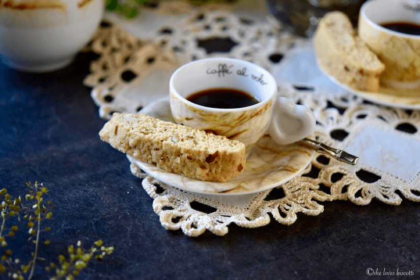 An espresso coffee with an Almond Biscotti.