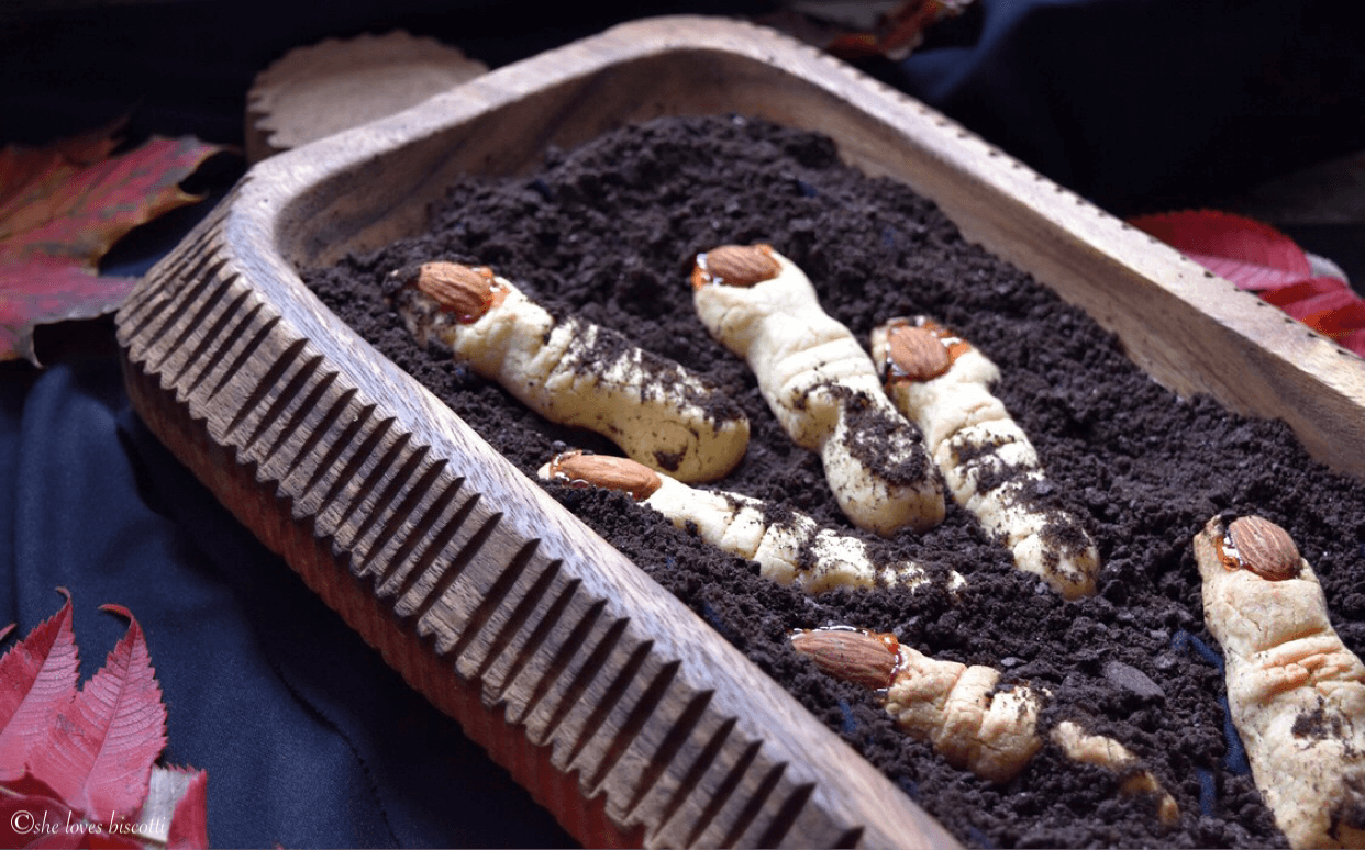 Witch fingers cookies scattered in chocolate crushed graham crackers. \(to resemble dirt\).