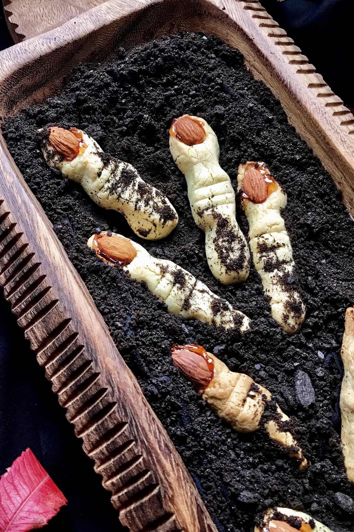 Witch fingers are placed on crushed graham chocolate cookies to resemble dirt.