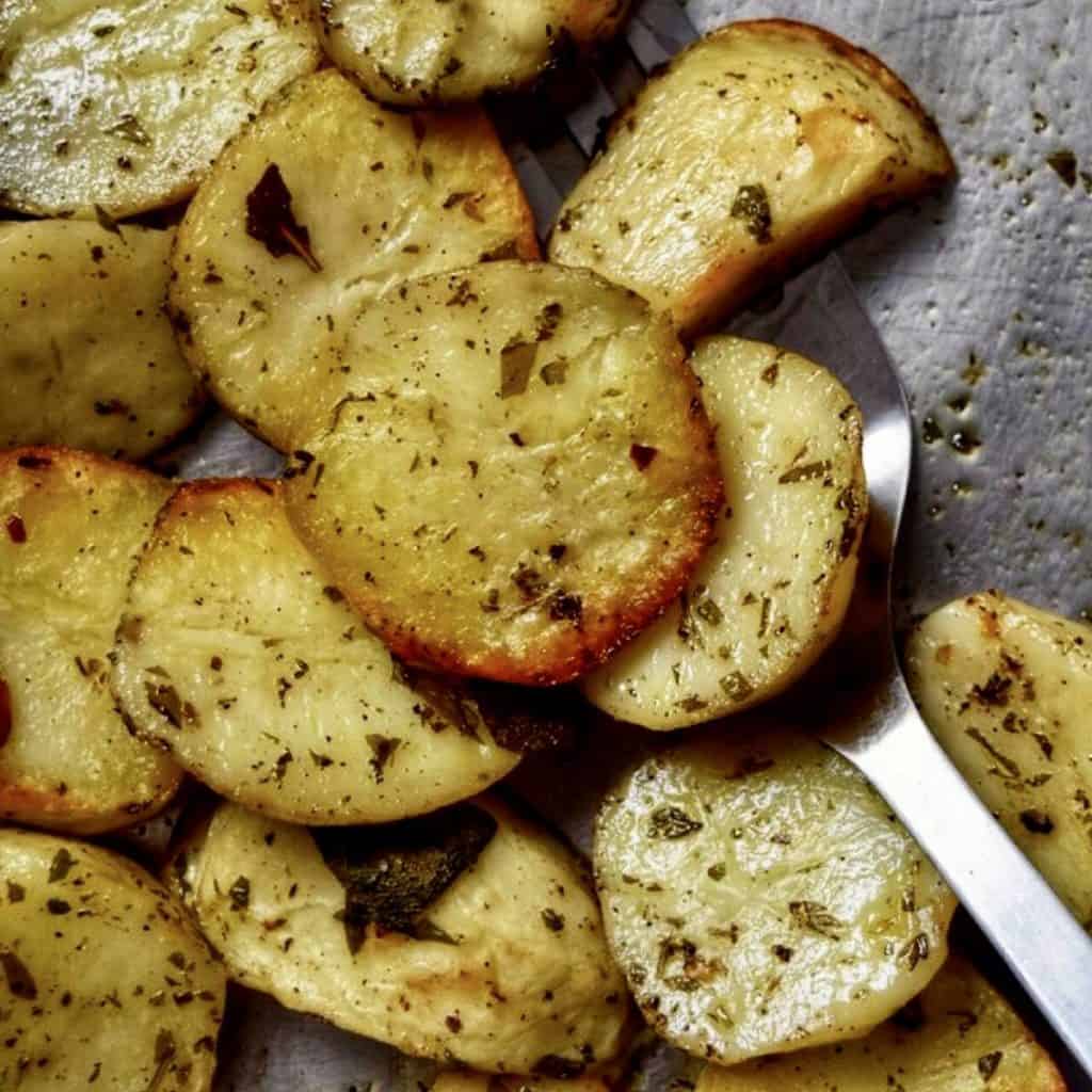 Crispy Italian Oven Roasted Garlic Potatoes in a sheet pan.