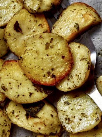 Crispy Italian Oven Roasted Garlic Potatoes in a sheet pan.