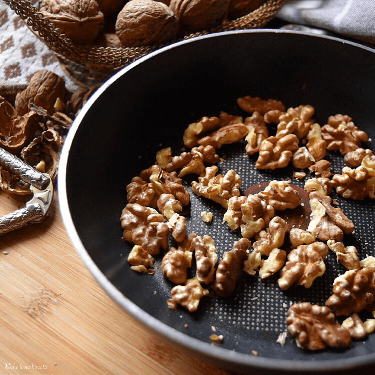 Toasting the walnuts in a small pan.