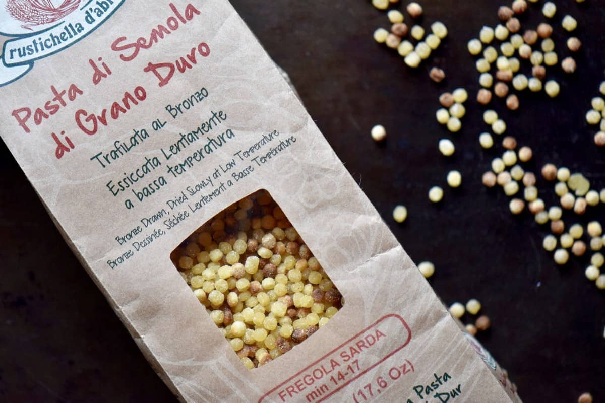 The package of fregola with a close up of the spherical semolina pasta.