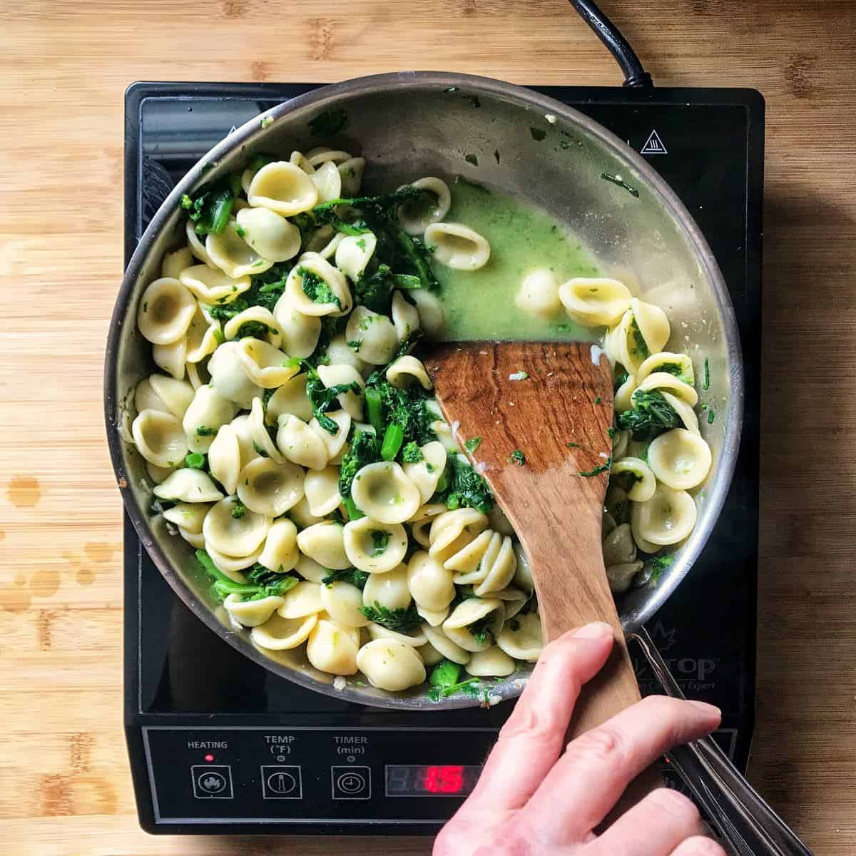 Broccoli Rabe Pasta being sauteed together in a pan.