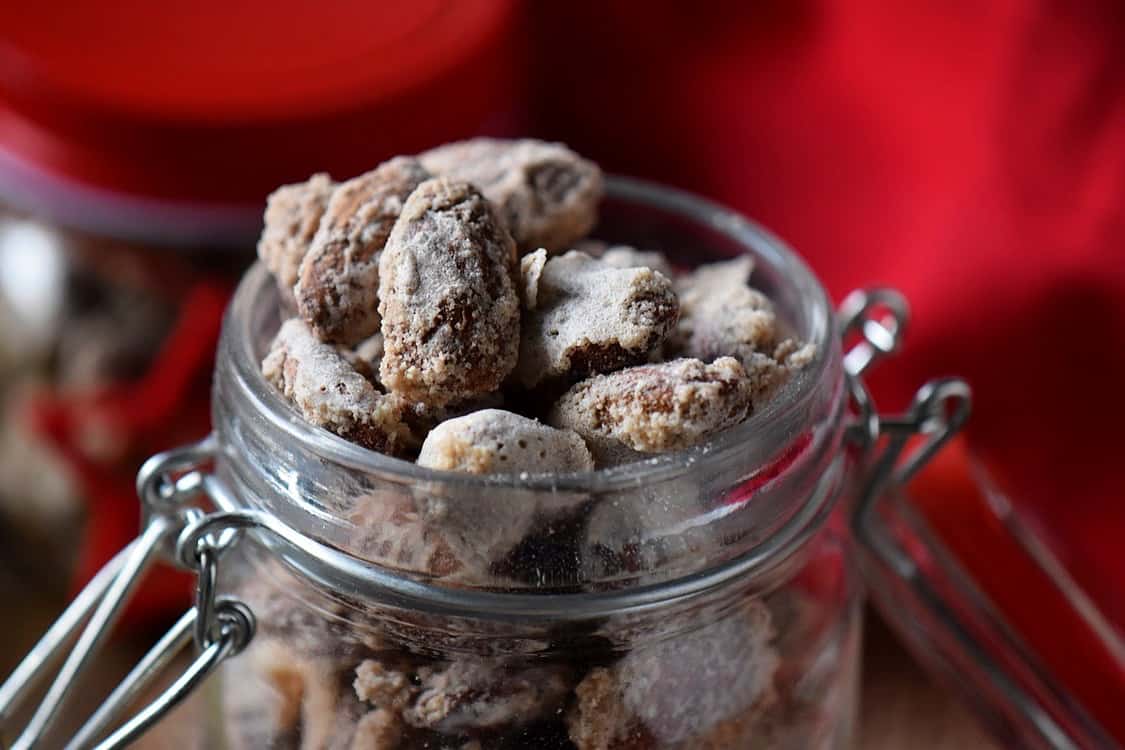 A mason jar filled to the brim with Oven Roasted Sugar Almonds.