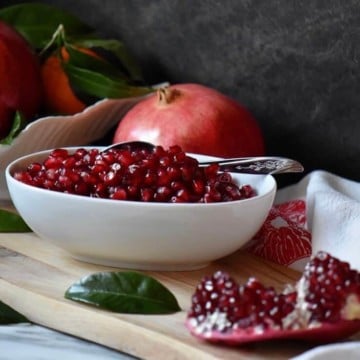 A bowl of ruby red pomegranate seeds.