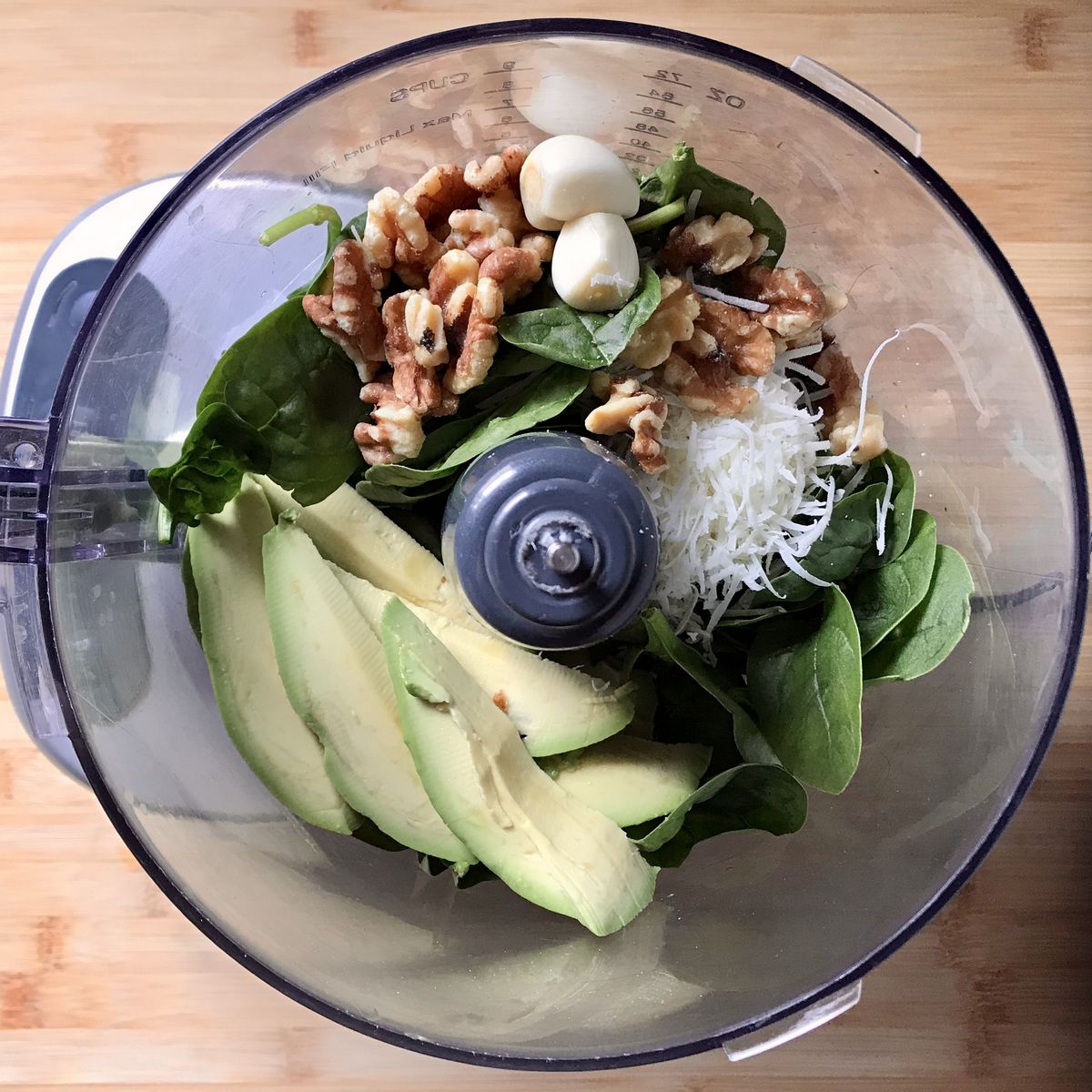 The ingredients for the Avocado Pesto Cavatelli Pasta Recipe are in a food processor.