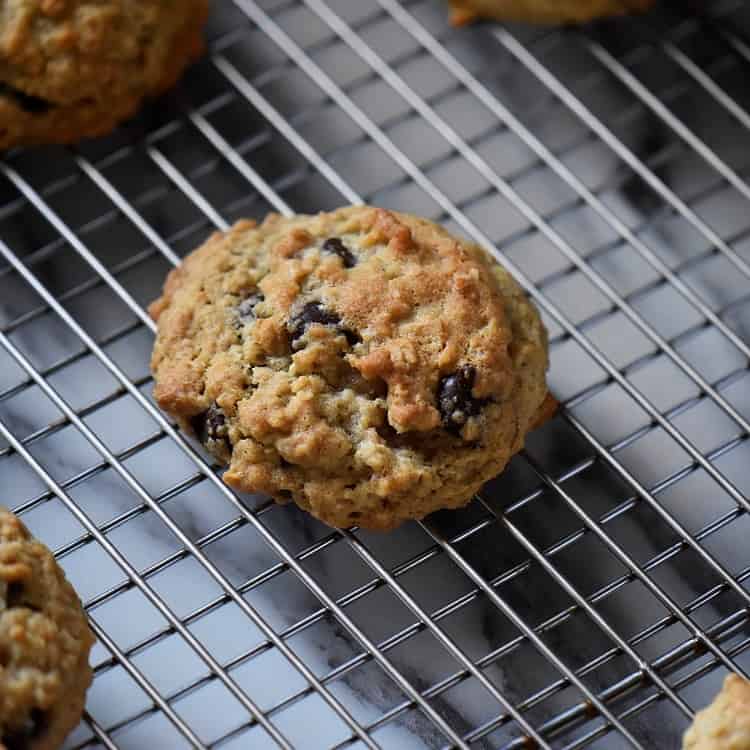 Thick and Chewy Oatmeal Chocolate Chip Cookies on a cooling rack.