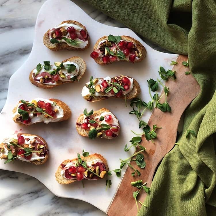 Colorful Whipped Ricotta Pomegranate Crostini Recipe ready to be served.