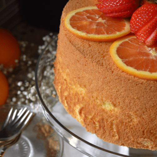 The Orange Chiffon Cake is is a cake platter decorated with sliced oranges.