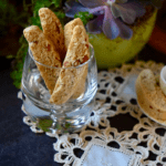 A few almond biscotti set upright in a glass.