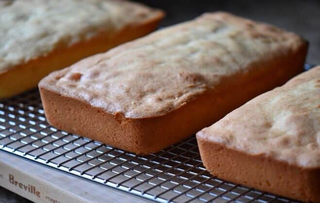 Three loaves of anise biscotti cooling off on a wire rack.