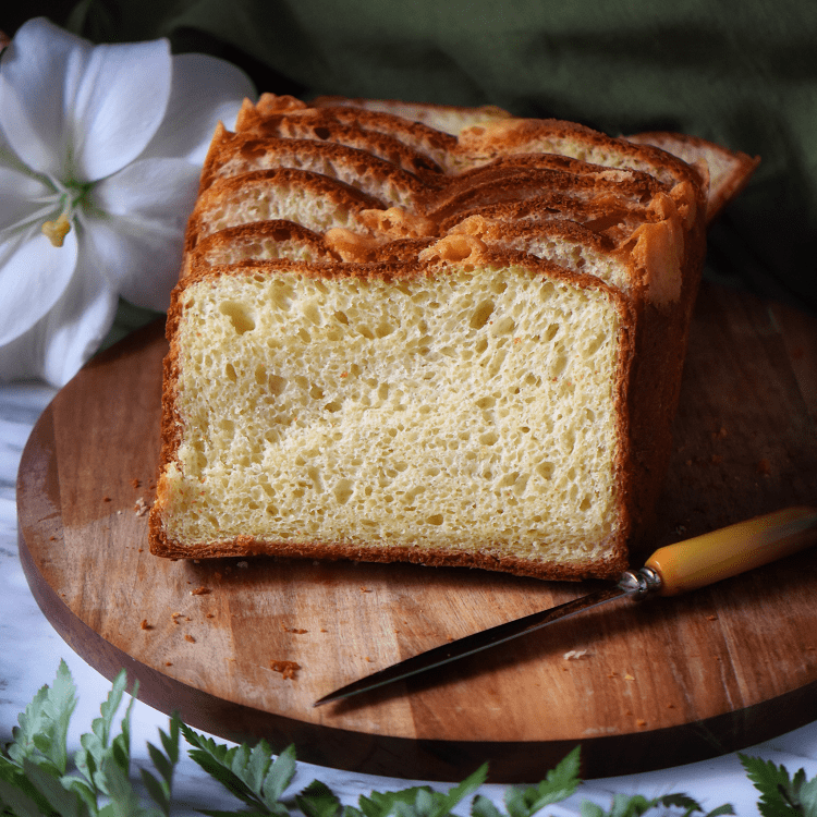 A loaf of the savory Italian Easter bread on a round wooden board.