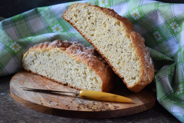 The loaf of an Irish soda bread is sliced to reveal the tender crumb.