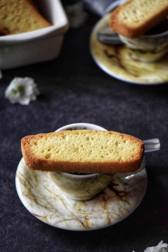 Italian biscotti placed on an espresso cup.