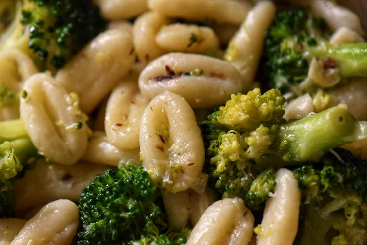 A close up of the combined broccoli and cavatelli in a saucepan.