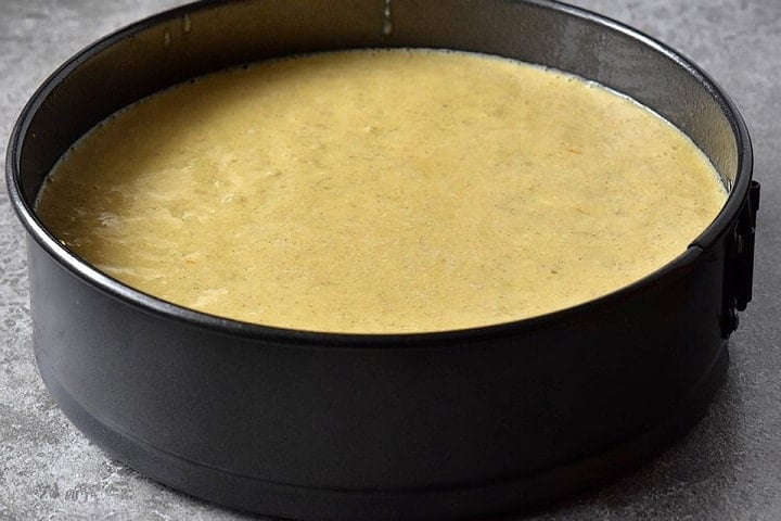 The unbaked rice ricotta filling in a spring form pan.