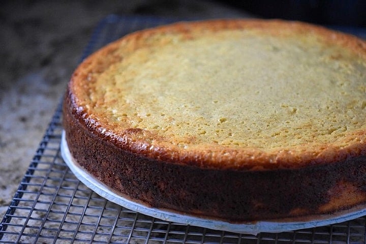 The freshly baked golden brown rice ricotta Easter pie cooling off on a cookie rack.