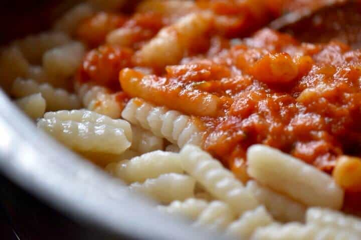 A close view of the homenade cavatelli and the red pepper sauce.
