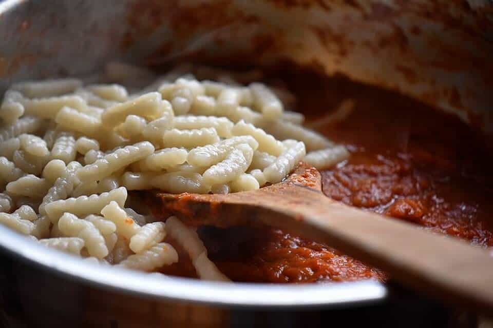 Homemade cavatelli added to the roasted red pepper sauce.