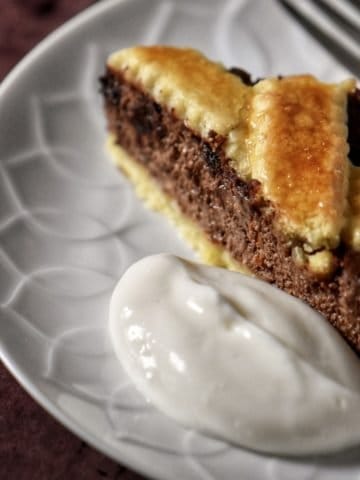 A chocolate tart on a cake platter.