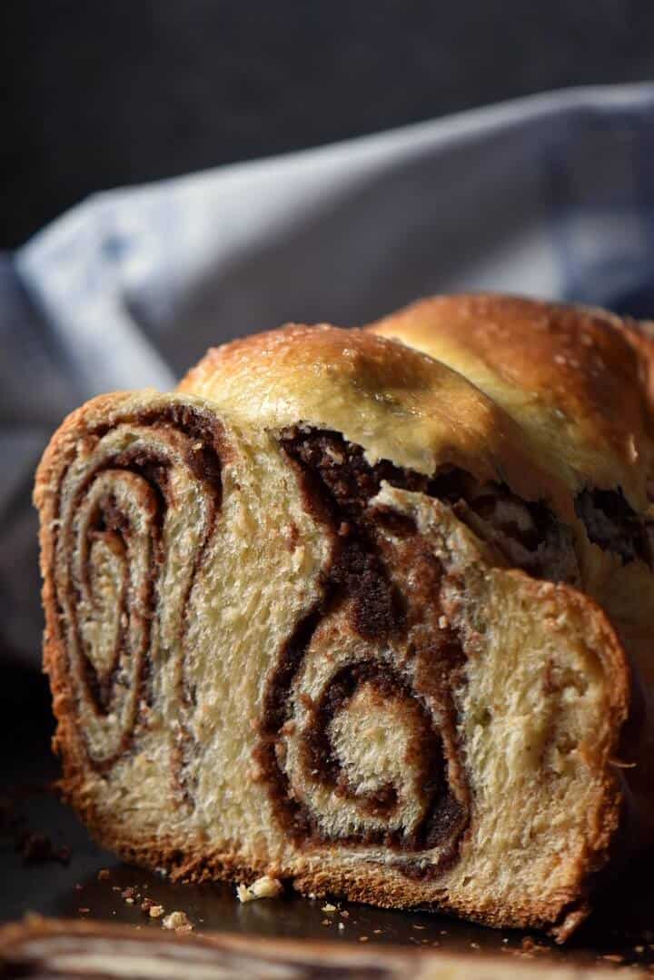 The chocolate nutty swirls of a sliced Romanian yeast bread called cozonac.