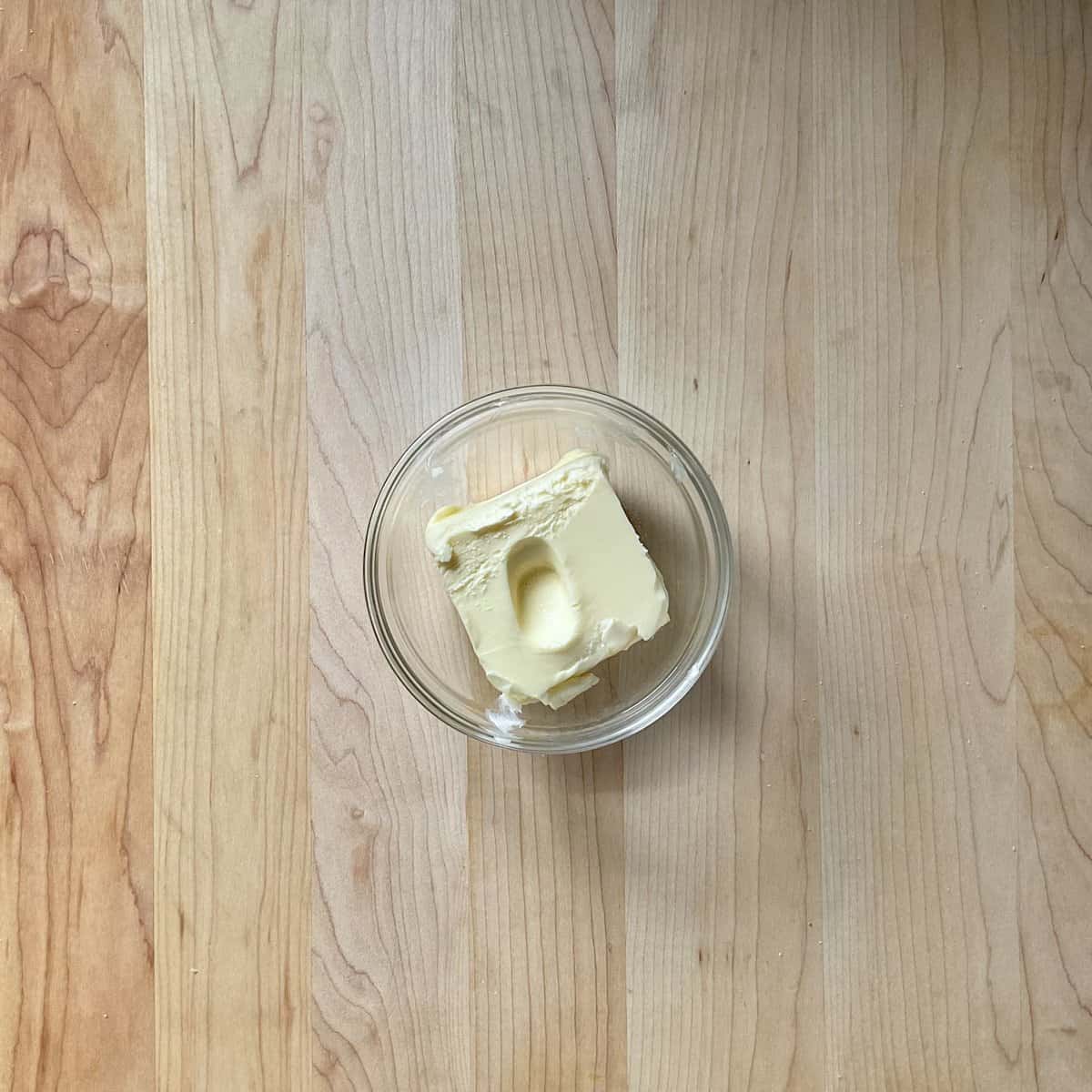 Room temperature butter in a small dish.