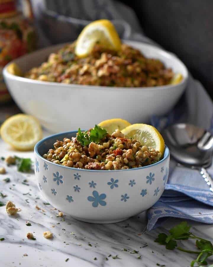 There are 2 bowls filled with Lentil Pasta Salad.