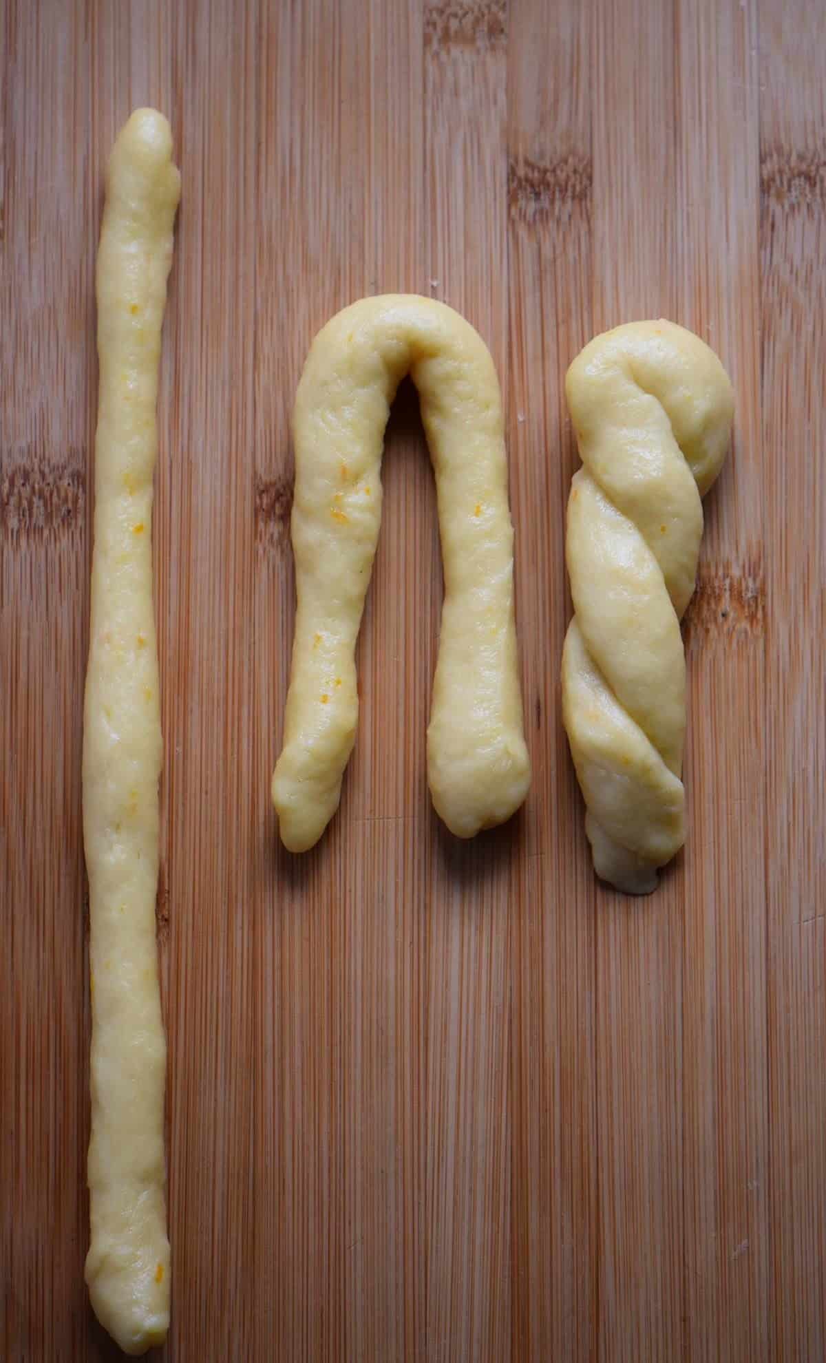 An overhead shot of how to make a hairpin koulourakia shape. 