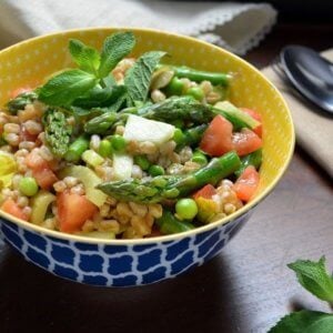 The colorful spring salad in a colorful yellow and blue patterned bowl.