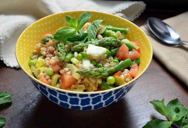 The colorful spring salad in a colorful yellow and blue patterned bowl.