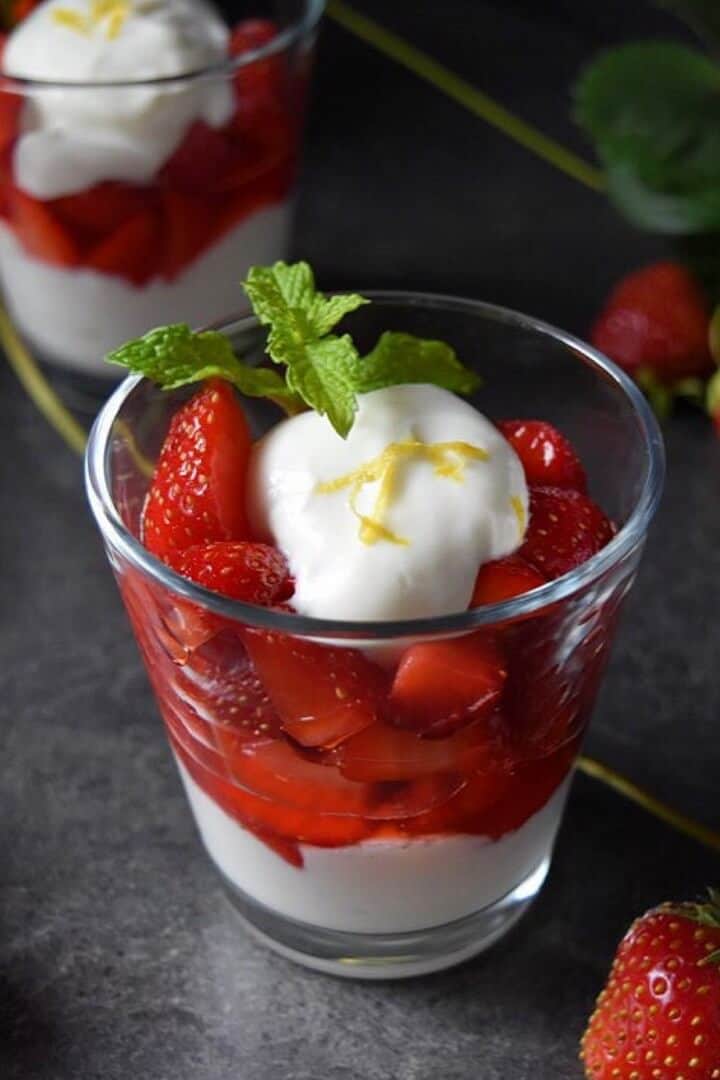 A close up of the macerated strawberries and whipped ricotta layered in a serving glass.