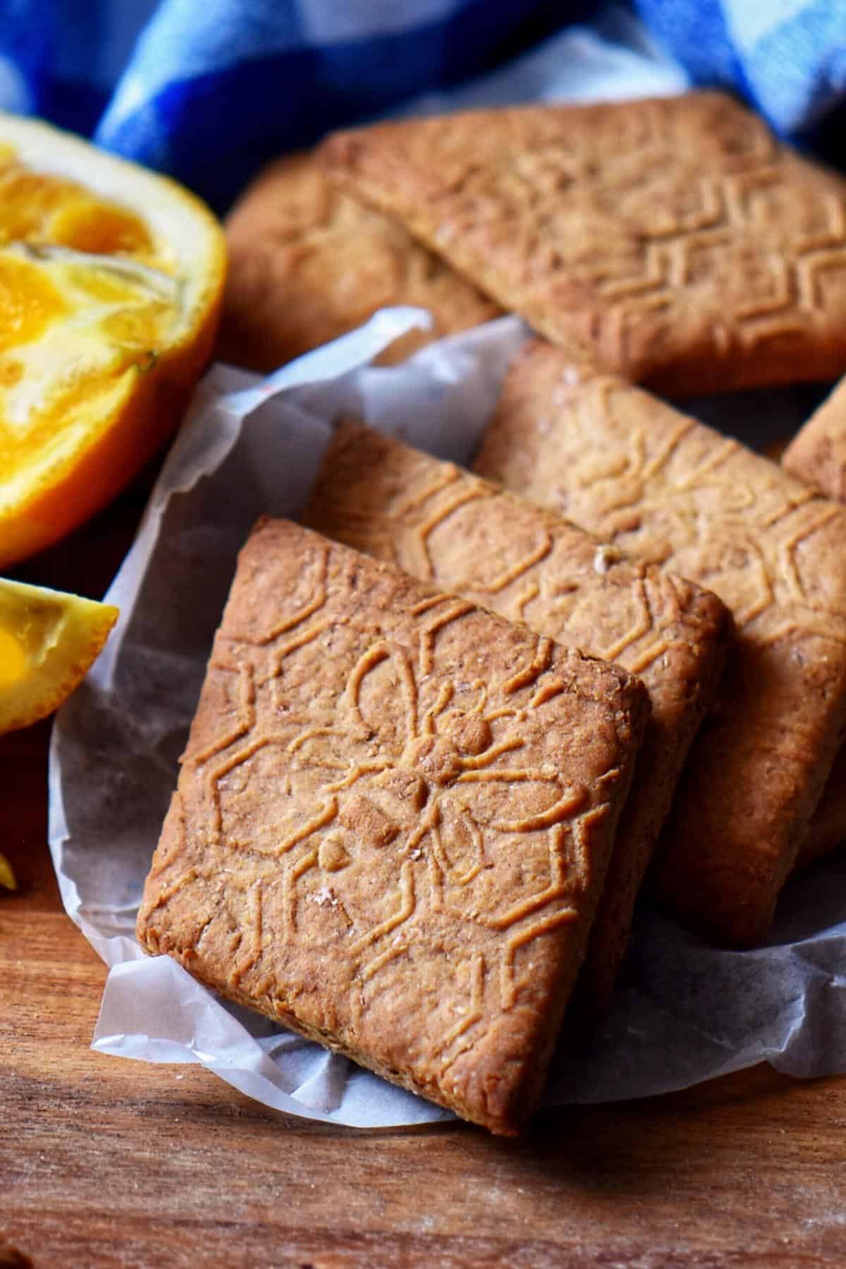 A stack of whole wheat biscuits on a wooden board.