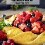 A colorful crostata made with strawberries, raspberries and blueberries.