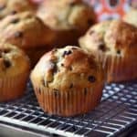 A chocolate chip muffin on a cooling rack.