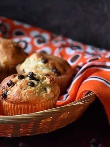 A basket of chocolate chip muffins.